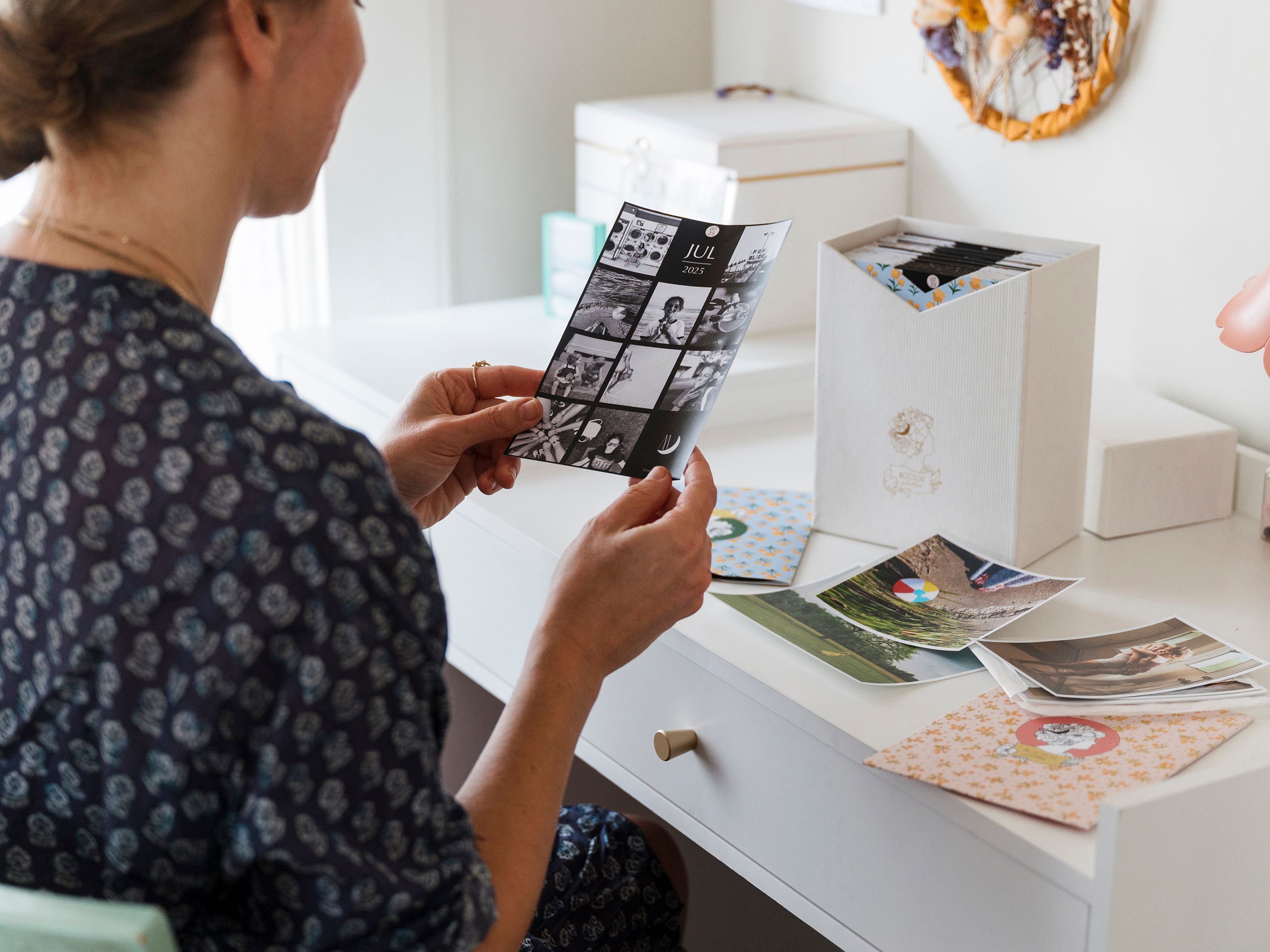 person looking at printed photos